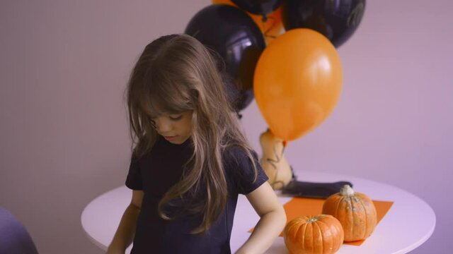 Cute girl scares and grimaces on halloween