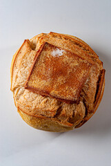 Close-up of a traditional round italian bread on white background.