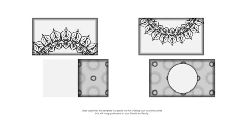 Business card preparation with Greek ornament. Business card design in White with black vintage patterns.