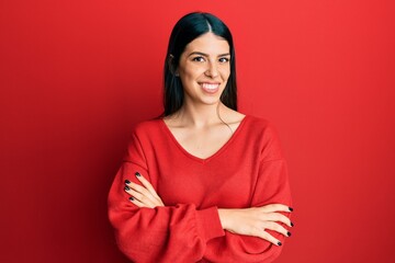 Young hispanic woman wearing casual clothes happy face smiling with crossed arms looking at the camera. positive person.