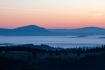 morning landscape with mountains and fog in the valleys