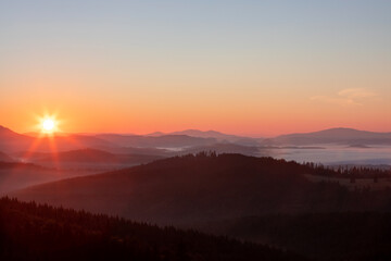 a beautiful landscape with hills and valleys at sunrise