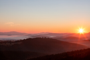 Naklejka na ściany i meble A beautiful landscape with sunrise over the mountains