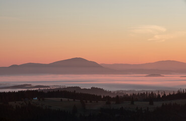 landscape with mountains and fog in the valleys in the morning