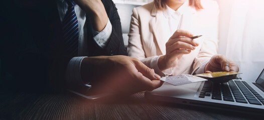 Fototapeta premium businesswoman hand using smart phone, tablet payments and holding credit card online shopping, omni channel, digital tablet docking keyboard computer at office in sun light