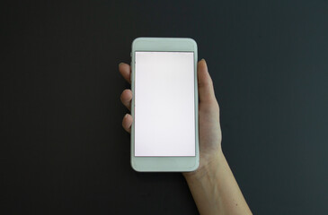 holding phone in hand on black background