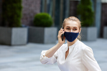 business woman in medical mask talking on phone