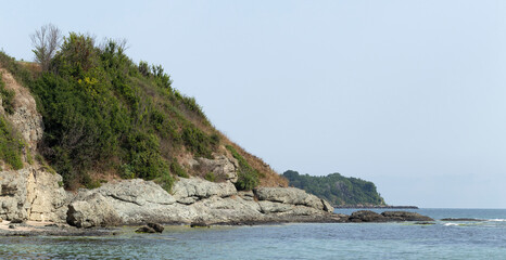 Fototapeta premium Black Sea coast. A seashore formed by frozen volcanic lava. Tectonic rocks.