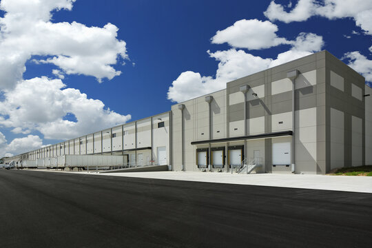 Modern gray and white industrial warehouse distribution building
