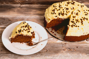Plate with slice of delicious chocolate cake topping with cream