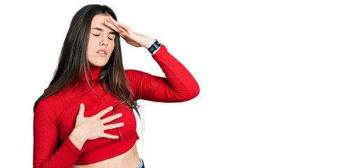 Young brunette teenager wearing red turtleneck sweater touching forehead for illness and fever, flu and cold, virus sick