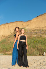 Happy young people running on beach and enjoying summer holiday. two young beautiful girls walking on beach