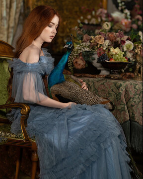 Red-haired girl in with a blue peacock in a retro room