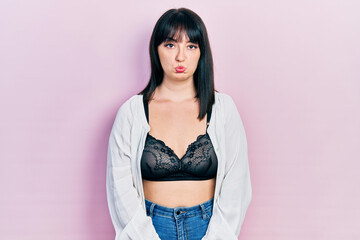 Young hispanic woman wearing lingerie depressed and worry for distress, crying angry and afraid. sad expression.