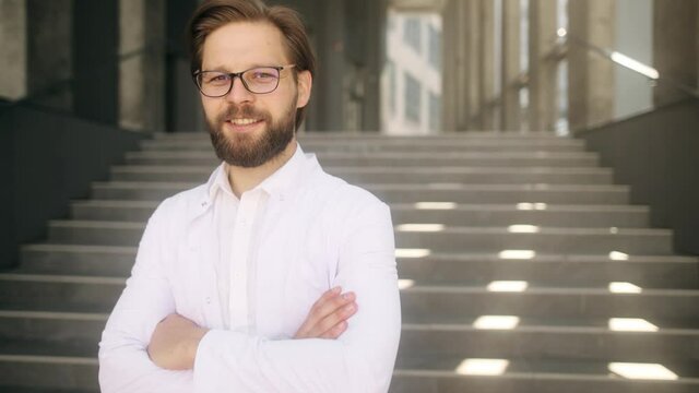 Close-up portrait of nice-looking handsome young medical worker looking into camera. Successful people. High quality 4k footage