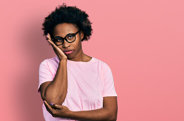 Fototapeta na wymiar African american woman with afro hair wearing casual clothes and glasses thinking looking tired and bored with depression problems with crossed arms.