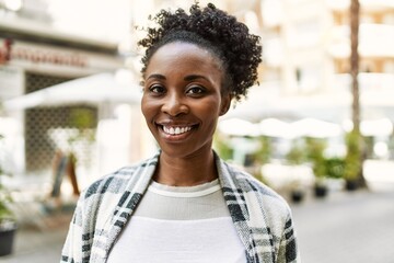 Young african american girl smiling happy standing at the city.