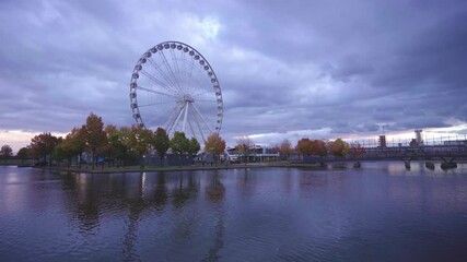 Montreal Observation Wheel or Great Wheel of Montreal  in the evening in fall. (Grande Roue de Montreal) in the Old Port. Ferris wheel on sunset.