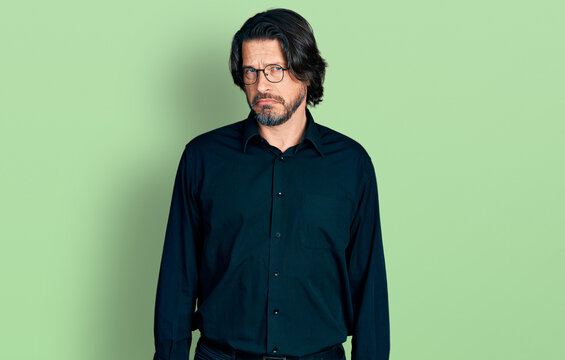 Middle age caucasian man wearing casual clothes and glasses skeptic and nervous, frowning upset because of problem. negative person.