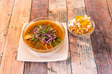 glass bowl with Ecuadorian onion recipe accompanied by a court bowl. Hot ceviche with lots of red onion and fresh coriander
