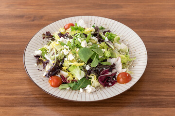 guacamole salad with goat cheese, cherry tomatoes and salad sprouts with olive oil, oregano and sea salt
