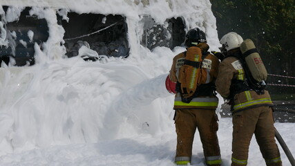Firefighters extinguish the fire with foam