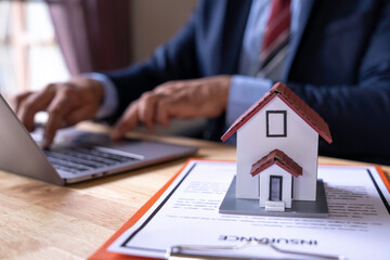 Man signing a contract when buying a new house Purchase agreement for ours with model home, Man sign a home insurance policy on home loans, Businessman signing contract insurance, Real estate concept