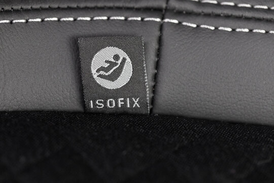 SOFIX sign on black leather background. ISOFIX for child car seats- Image