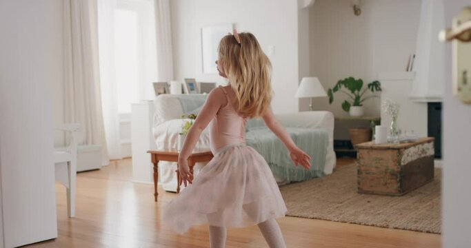 cute little girl dancing playfully pretending to be ballerina happy child having fun playing dress up wearing ballet costume at home 4k