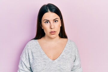 Fototapeta premium Young hispanic woman wearing casual clothes relaxed with serious expression on face. simple and natural looking at the camera.