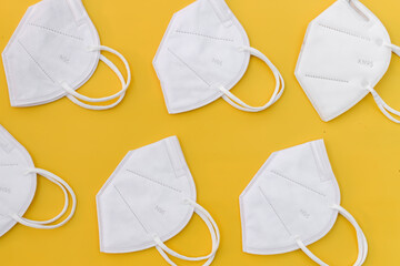Protective face masks isolated on yellow background