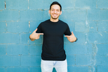 Excited man wearing a black casual t-shirt - obrazy, fototapety, plakaty