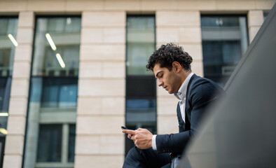 A financier makes a call to a colleague on a mobile phone. A bank employee near the office. A...