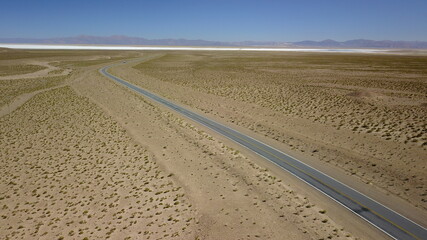Naklejka premium route in desert on high plain shot with drone