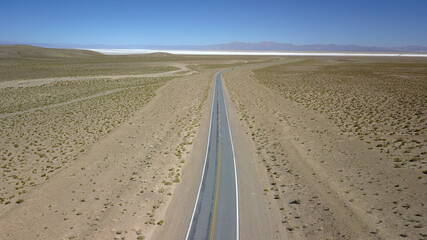 Naklejka premium route in desert on high plain shot with drone