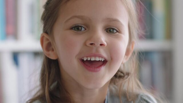 portrait beautiful little girl smiling with natural childhood curiosity looking joyful child with innocent playful expression 4k footage