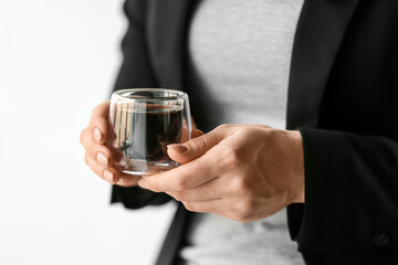 Woman with cup of hot turkish coffee on white background, closeup