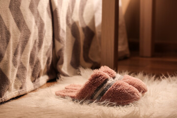Beautiful soft slippers on rug at home