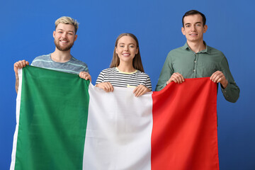 Young people with flag of Italy on color background