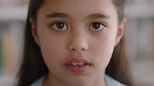 portrait happy little girl with natural childhood innocence looking joyful child with serious expression 4k footage