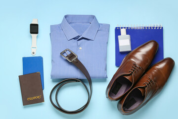 Stylish male clothes, smartwatch and accessories on color background