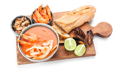 Bowl of tasty Cacciucco soup and ingredients on white background