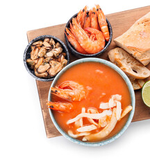 Bowl of tasty Cacciucco soup and ingredients on white background, closeup