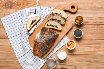 Composition with tasty poppy seed bun on wooden background