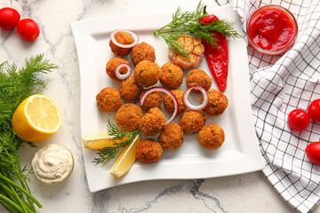 Plate with tasty cod cutlets and sauces on light background