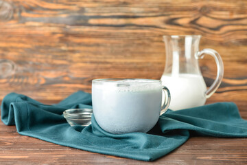 Glass cup of tasty Charcoal Latte on wooden background