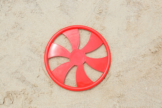 Red Frisbee Disk On Sand