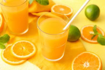 Glasses of tasty orange juice on color background, closeup