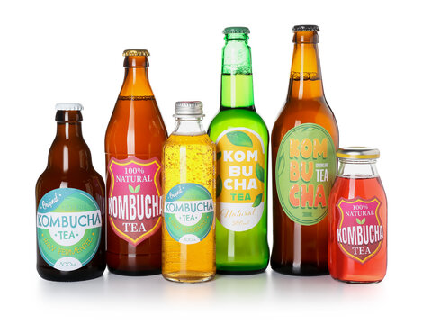 Different kombucha tea in bottles on white background