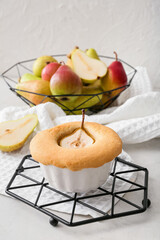 Grid with tasty pear pot pie on light background